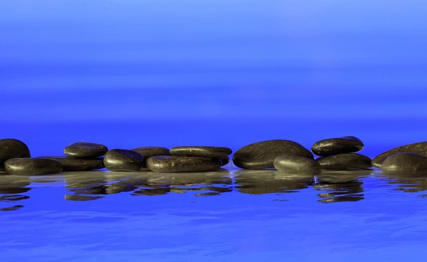 selfcare calm seas with black rocks lined up