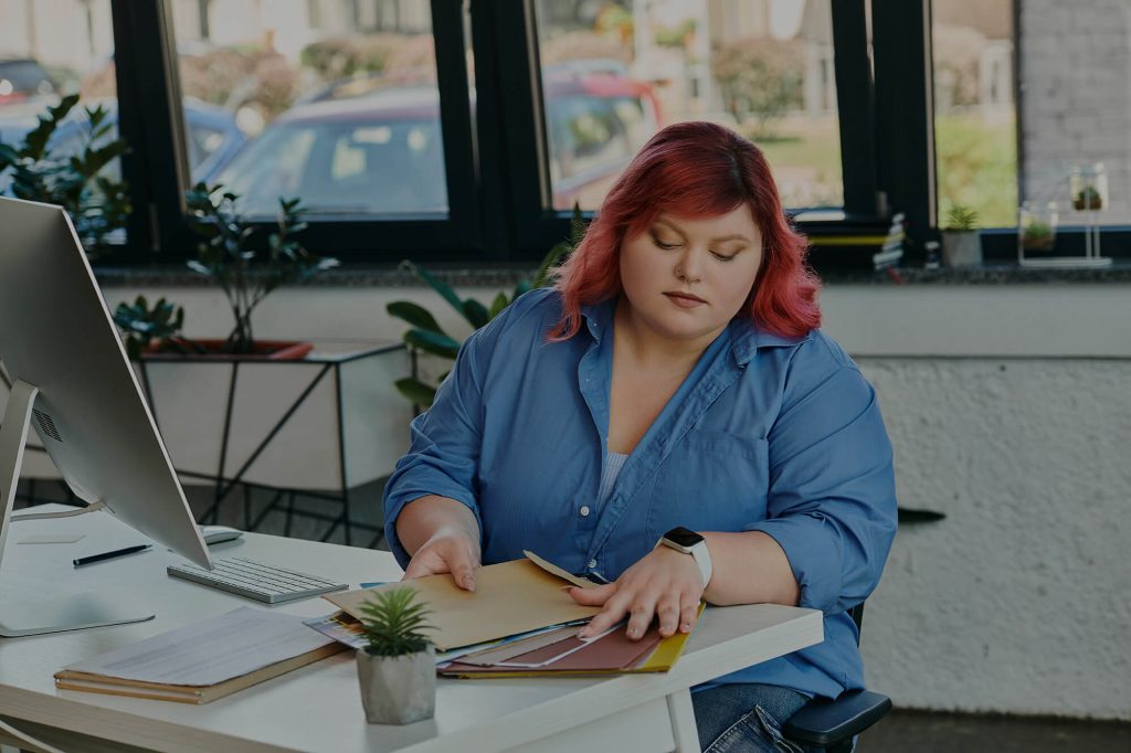 AI in Psychotherapy with young therapist working on her notes in front of computer