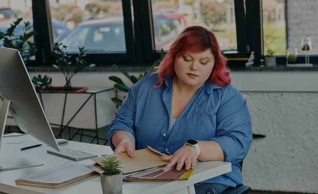AI in Psychotherapy with young therapist working on her notes in front of computer